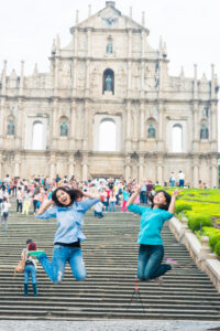 Image of girls jumping in Senado Square on girls trip in Macao