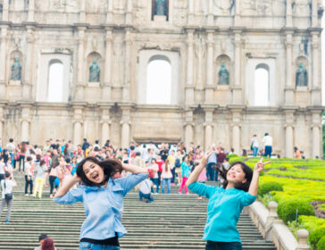 Image of girls jumping in Senado Square on girls trip in Macao