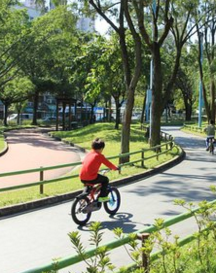 Child cycling on the bike path near Kowloon Walled City Park