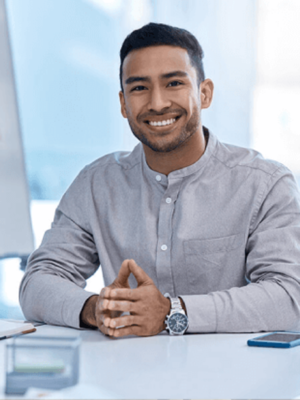 happy tax consultant sitting at desk in singapore