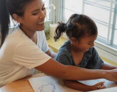 Image of helper with child - hiring a helper singapore