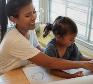 Image of helper with child - hiring a helper singapore
