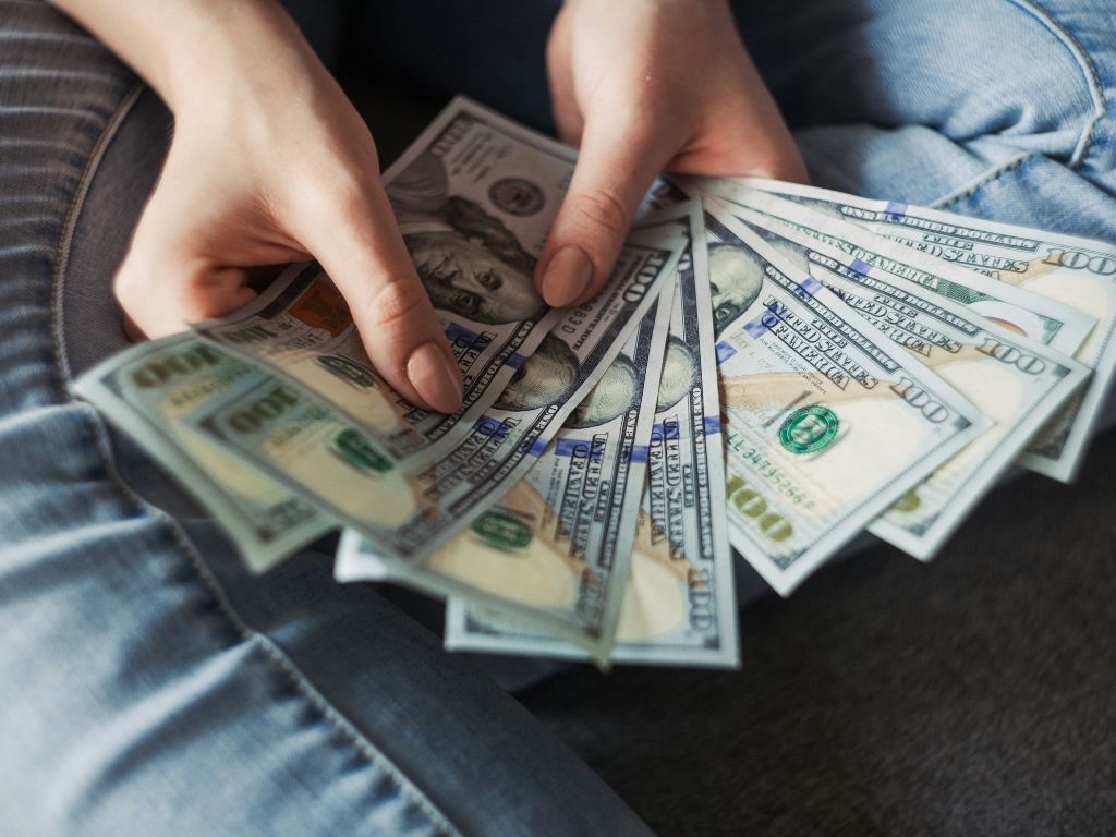 Image of woman holding money - matrimonial assets - divorce singapore