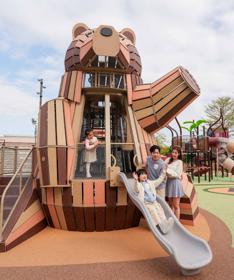 Giant wooden bear play structure with a slide at GO PARK Sai Sha
