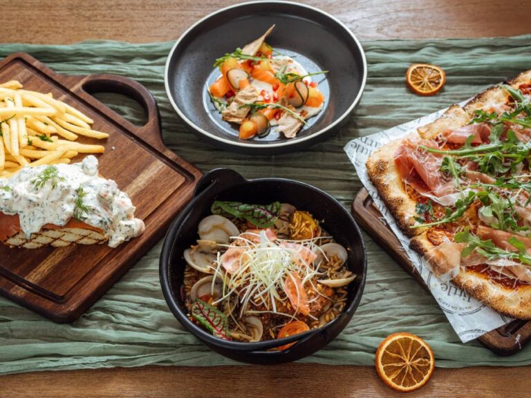 Table by Little Farms waterfront restaurant in Sentosa with a table of delicious food