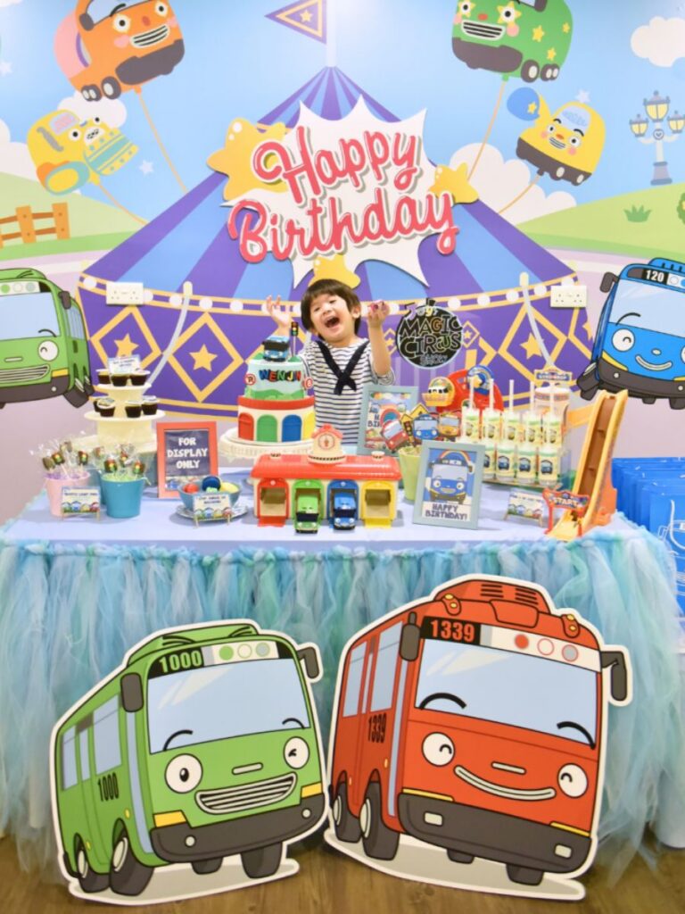 Image of boy with birthday cake and Tayo decor at Tayo Station - indoor birthday party venue singapore