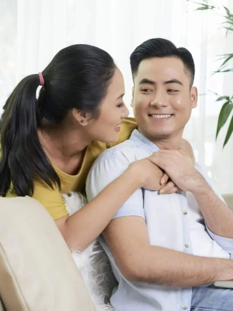 Image of woman hugging man at home - marriage counseling singapore
