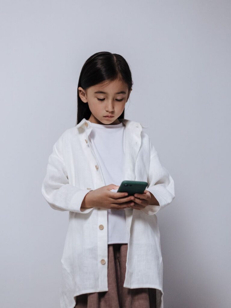 Image of asian girl using a phone - Tinkle Friend - counselor singapore