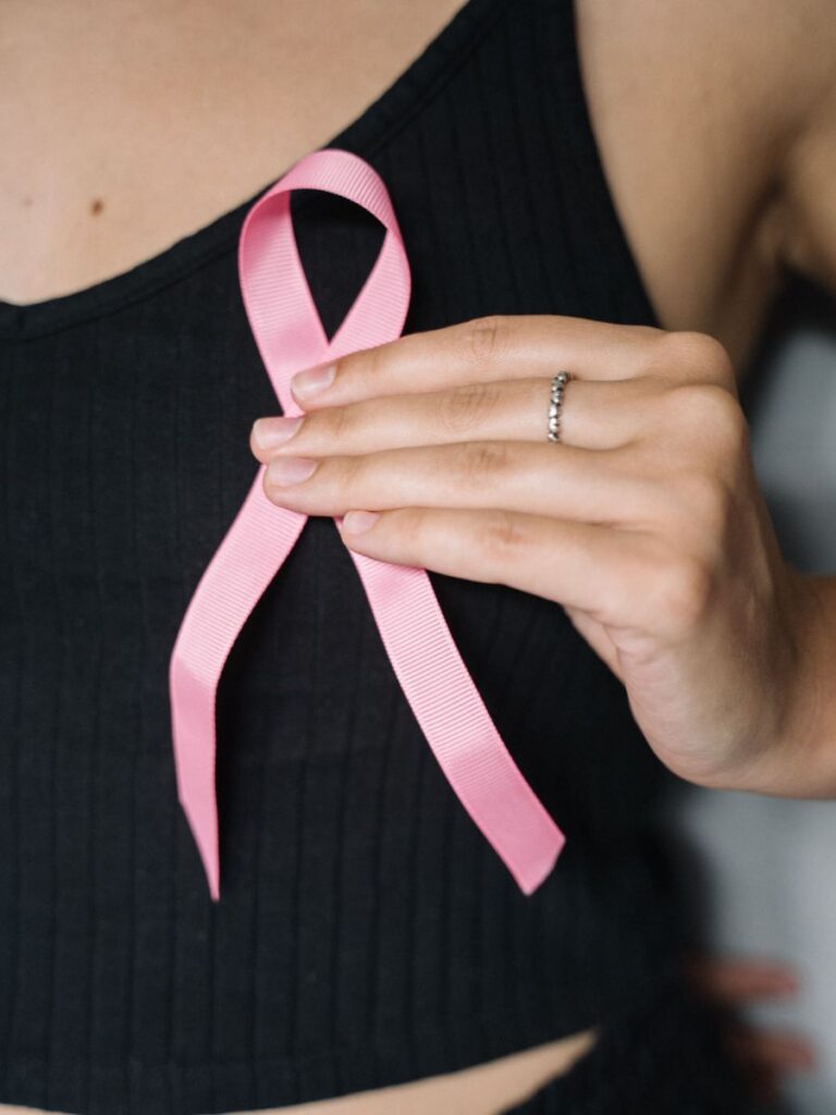 Image of woman holding pink ribbon - breast cancer awareness event singapore