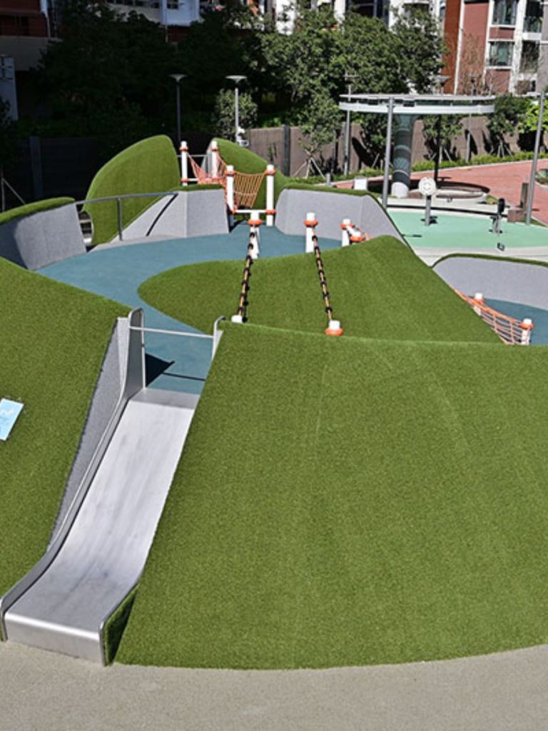 Grass mounds and slide at Kai Tak Avenue Park in Kowloon City