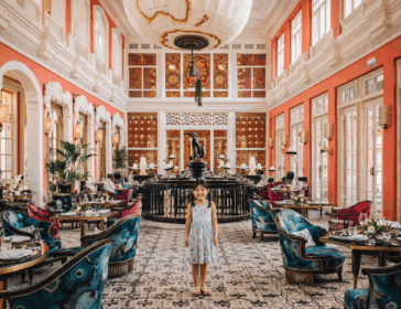 Child standing in a grand, colorful hotel at a family-friendly luxury resort in Phu Quoc, Vietnam.