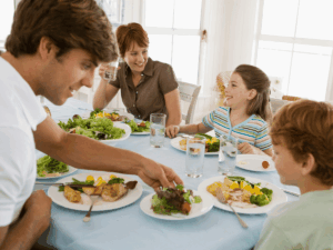happy family of four eating healthy dinner together in Singapore