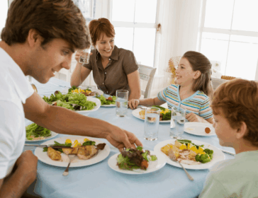 happy family of four eating healthy dinner together in Singapore