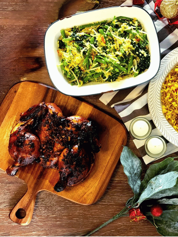 roast balinese chicken on wooden board with mixed green vegetables