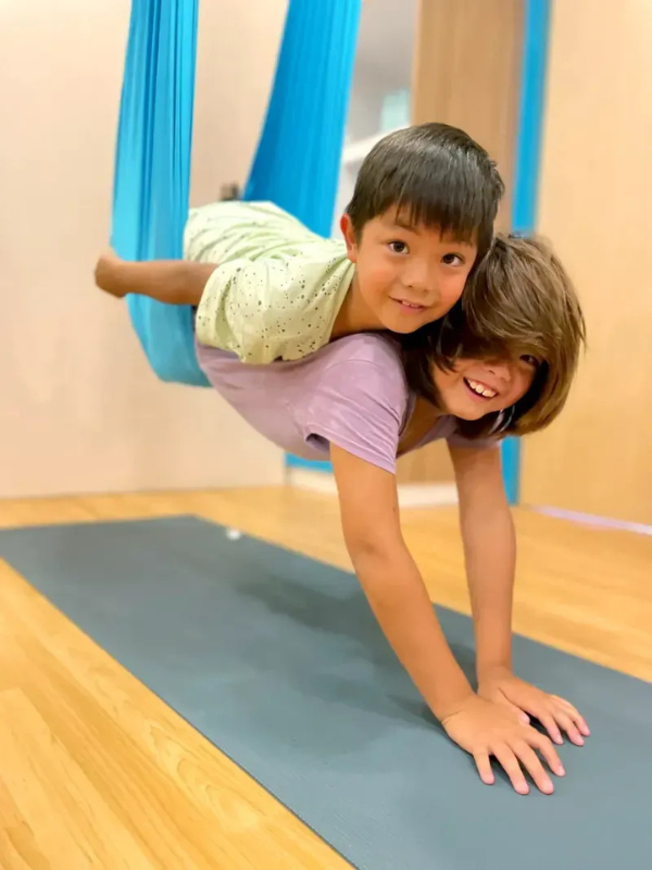 two children on an aerial yoga hammock at Mindful Space Singapore Little Steps