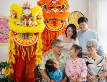A multi-generational family posing together in festive outfits during a Chinese New Year family photoshoot in Singapore.