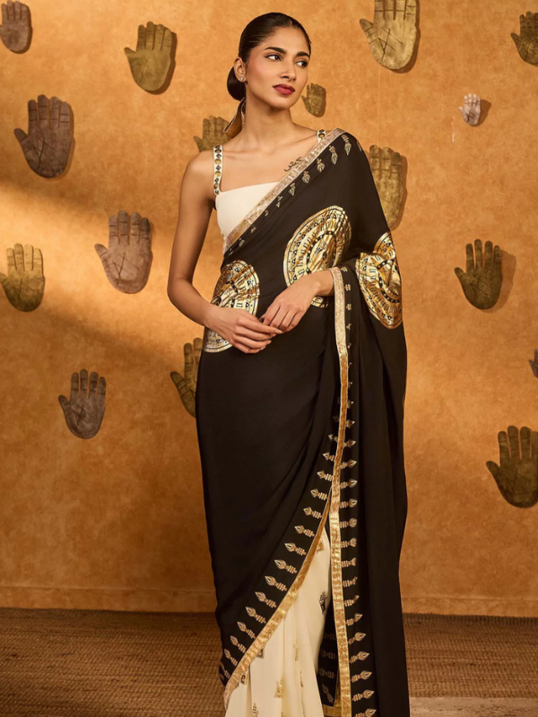 beautiful indian woman wearing a black and gold sari