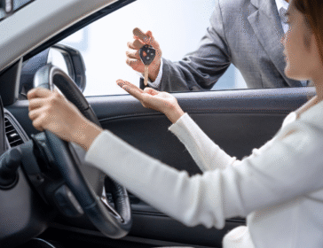 woman receiving keys to her leased car in singapore