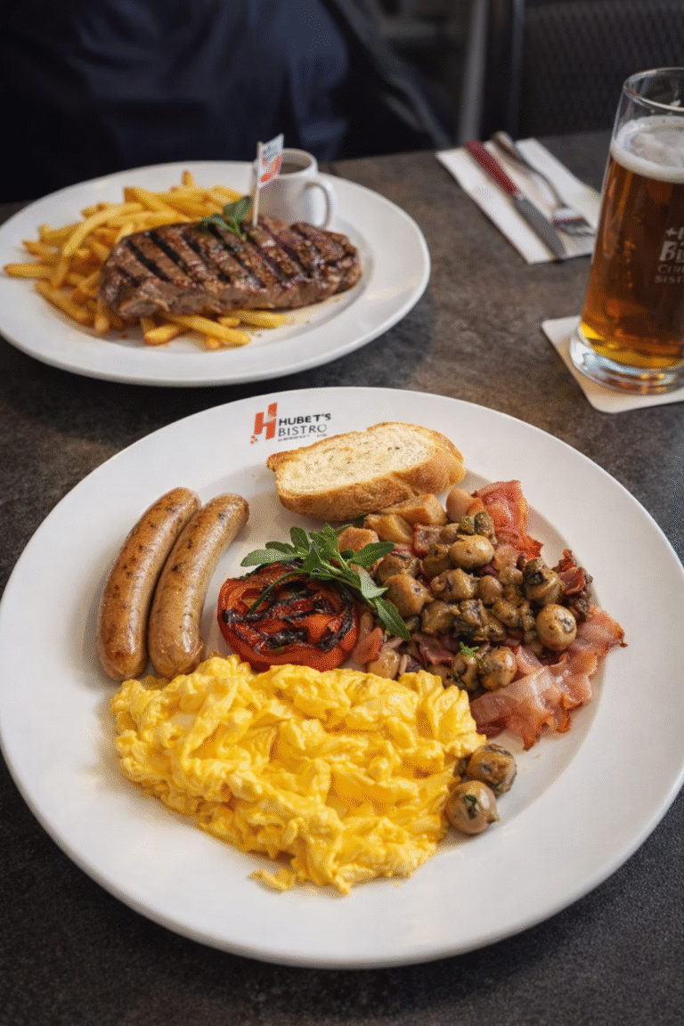 European breakfast plate with sausages, eggs, and bread at Hubers Bistro in Dempsey Hill, Singapore