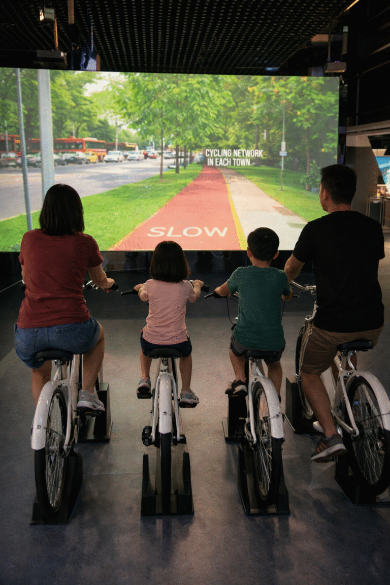 Family cycling indoors near the Marina Barrage Gallery in Singapore
