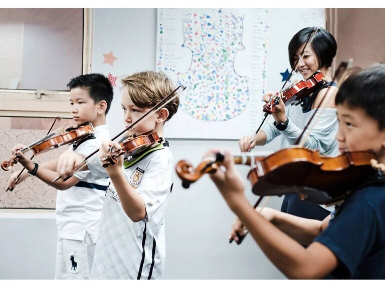 Children learning violin at Hong Kong Suzuki Music Institute