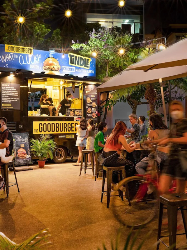 food truck with tables around it serving the goodburger offerings