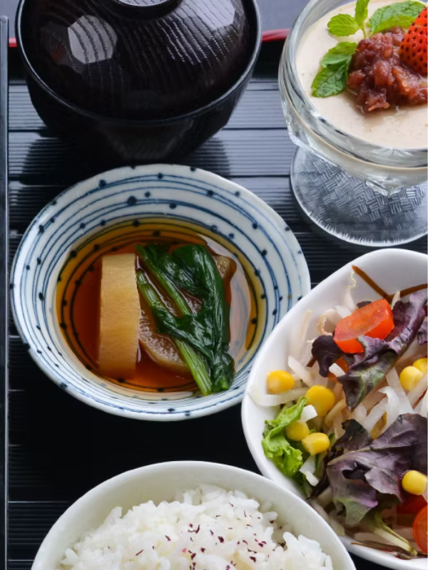 vegetarian soups, salad and rice in dishes on a wooden table