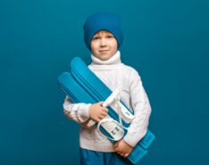 Image of child carrying skiis to new Snow Monster classes and camps in Singapore