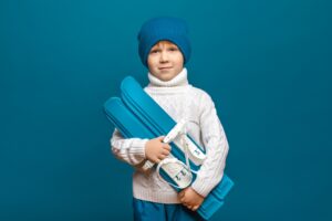 Image of child carrying skiis to new Snow Monster classes and camps in Singapore