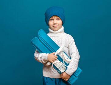 Image of child carrying skiis to new Snow Monster classes and camps in Singapore