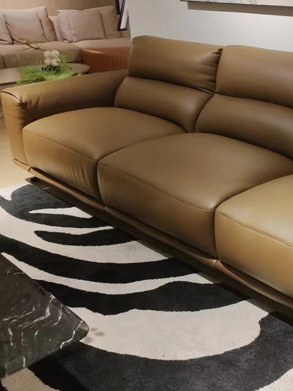 brown leather lounge with zebra patterned rug