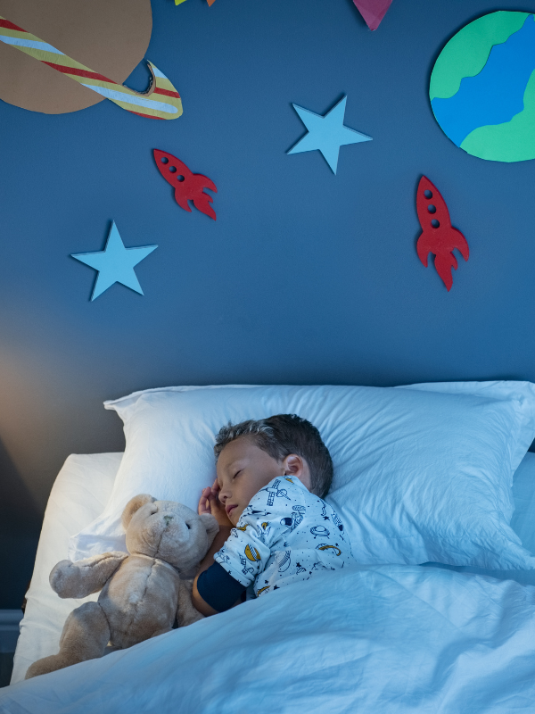 child asleep in a blue room