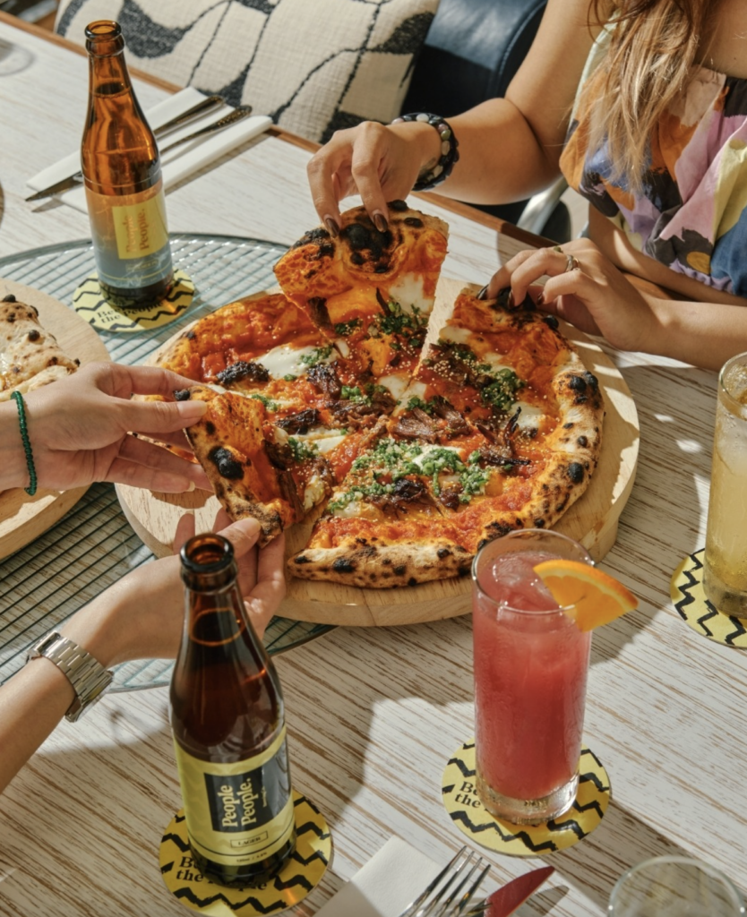 Family enjoying wood-fired pizza and activities during People People Family Day at Resorts World Sentosa Singapore