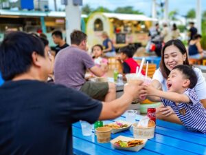 Family dining at Palawan Food Trucks Sentosa beach