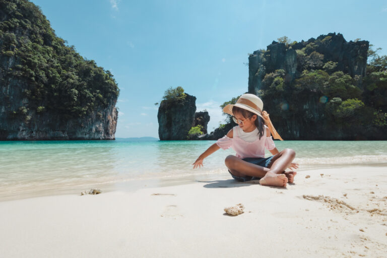 Child playing with sand in Phuket, Thailand
