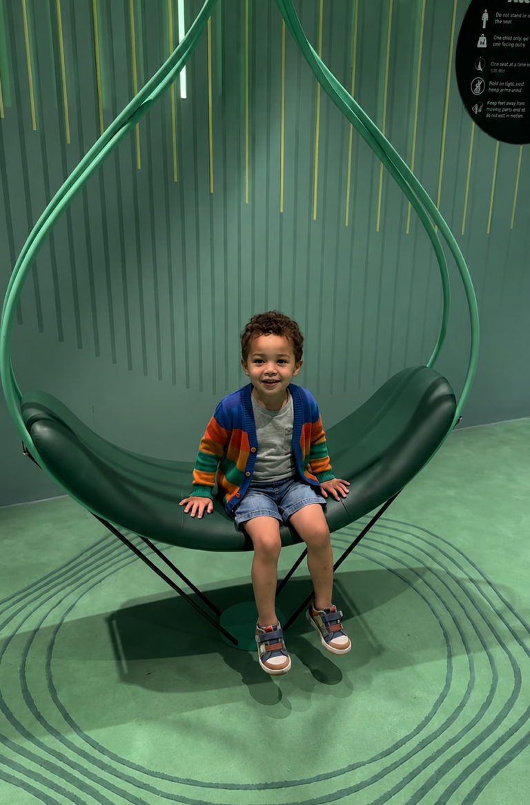 Kid on a swing at the Fit and Fun Zone indoor playground in Changi Airport