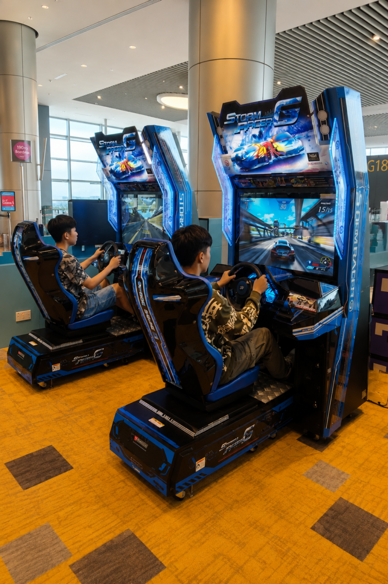 Teens playing free video games at Changi Airport Singapore