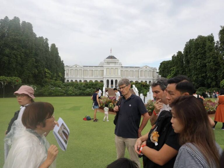 Visitors exploring the Singapore Istana Open House grounds with families and live performances