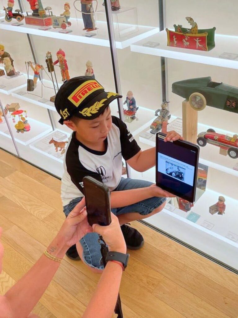 Image of boy with vintage toys - kid-friendly museum singapore