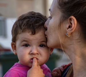 Image of mother and baby celebrating world refugee day in Singapore