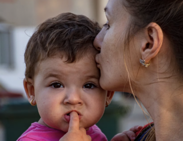 Image of mother and baby celebrating world refugee day in Singapore