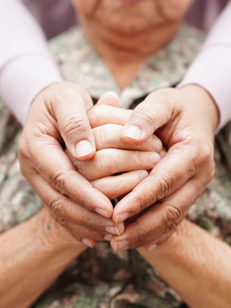 Image of two people holding hands