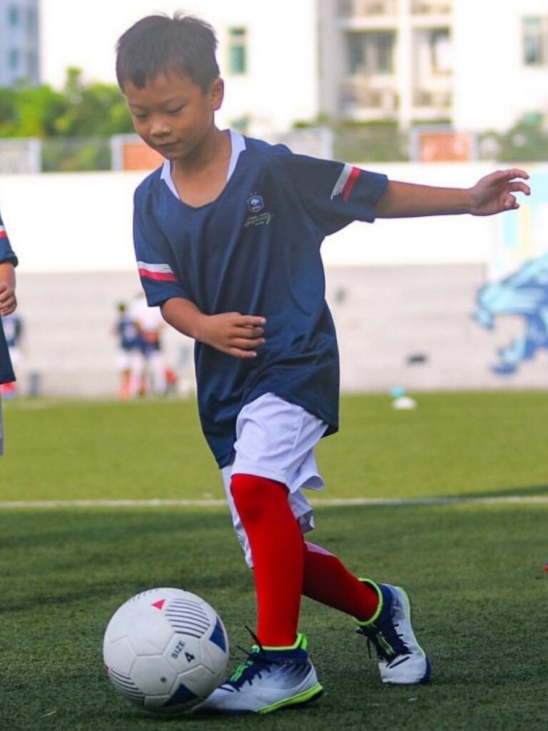 Image of boy playing football - enrichment class singapore