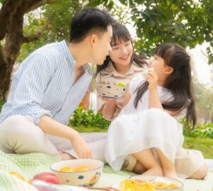 Image of Asian family in the park - life insurance singapore