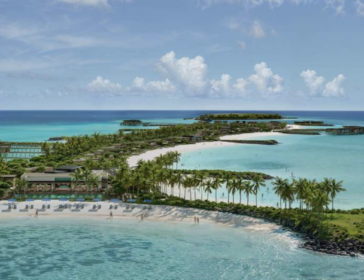Aerial view of Bvlgari Resort Ranfushi's beach and overwater villas on Raa Atoll, Maldives, with calm turquoise lagoon