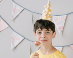 Boy in a party hat at a kids birthday party in Hong Kong