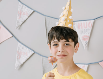 Boy in a party hat at a kids birthday party in Hong Kong