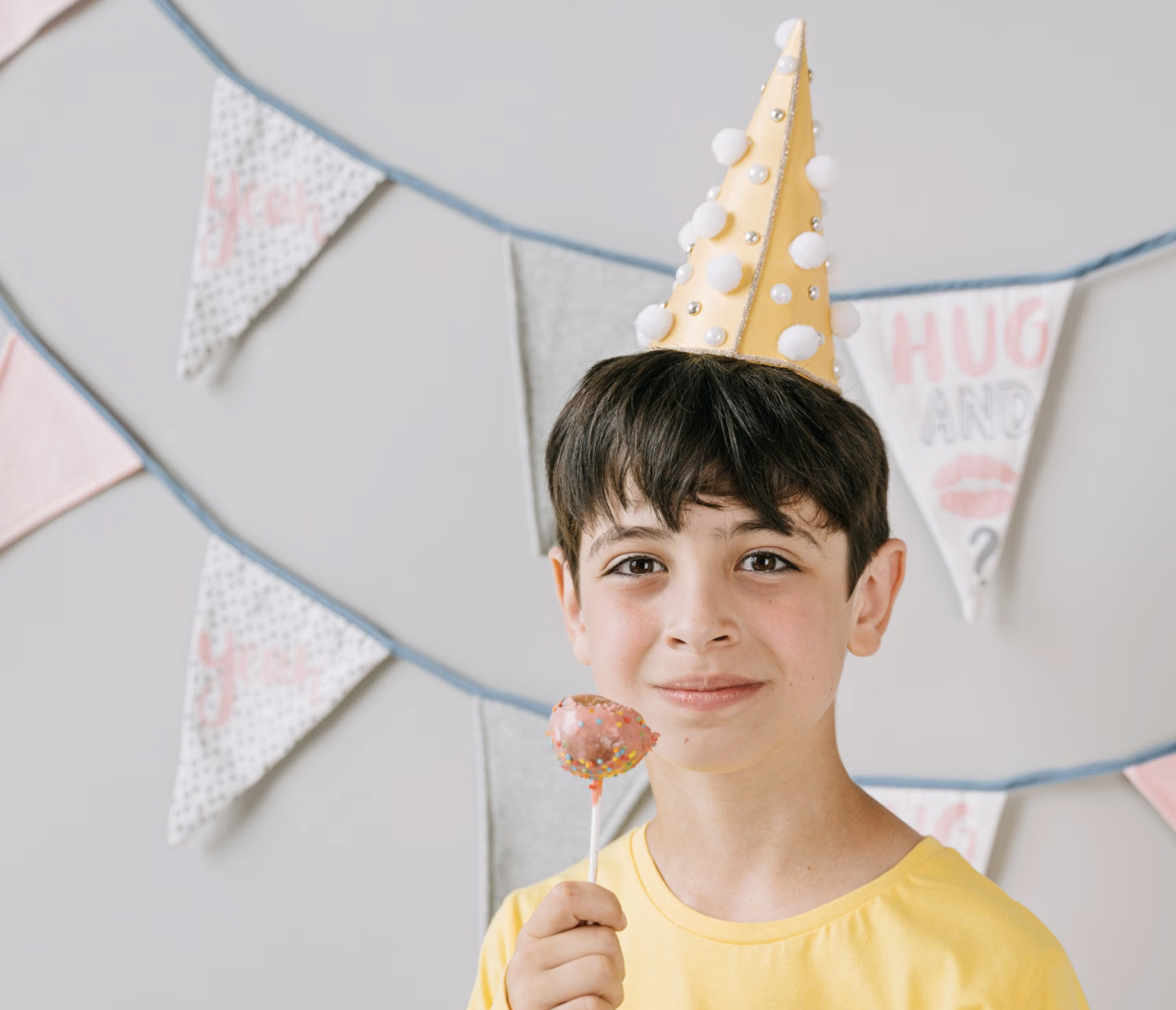 Boy in a party hat at a kids birthday party in Hong Kong