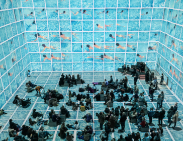 Families relax on a floor of rippling blue water as Hockney's swimmers fill every wall at the Bigger & Closer immersive show